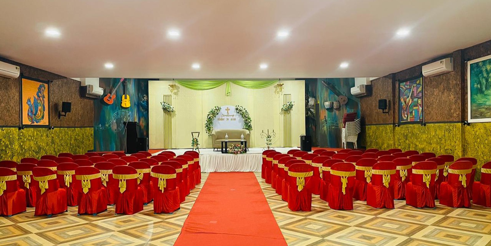 Actual auditorium at Sylvan Hills arranged with chairs and a decorated stage